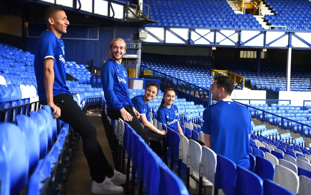 Smiling football players enjoying their time in the stadium.